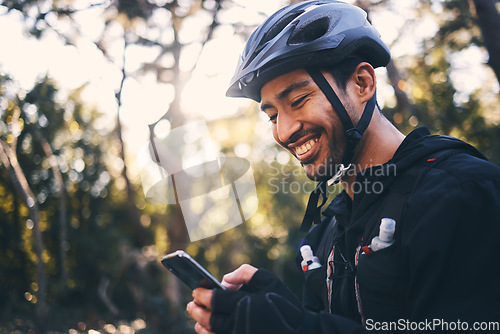 Image of Cycling, phone and smile with man in nature for search, networking and connection. Relax, happy and social media with male cyclists in forest park for training, sports and internet browsing