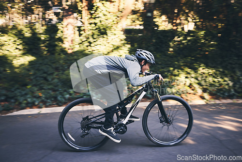 Image of Cycling, nature and fitness with man in road for training, workout or cardio exercise. Adventure, extreme sports and speed with male cyclist on bike in forest park for performance, challenge or break