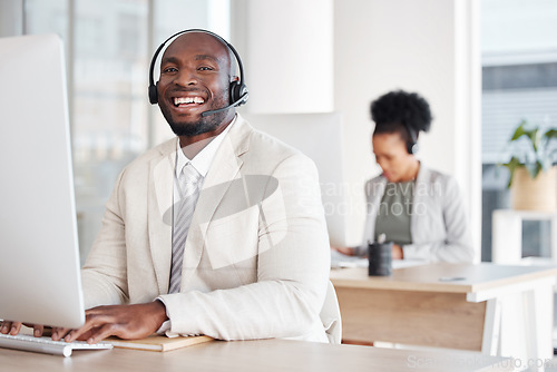 Image of Call center, portrait and black man consulting for crm, telemarketing and customer service with a smile. Happy, face and male consultant in office for online help, support and faq or contact us