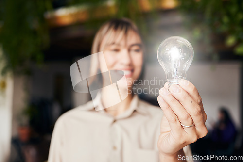 Image of Lightbulb, happy and a woman with light from inspiration, knowledge or ideas at work. Smile, innovation and an employee with power, creativity and energy at a company with optimism and vision