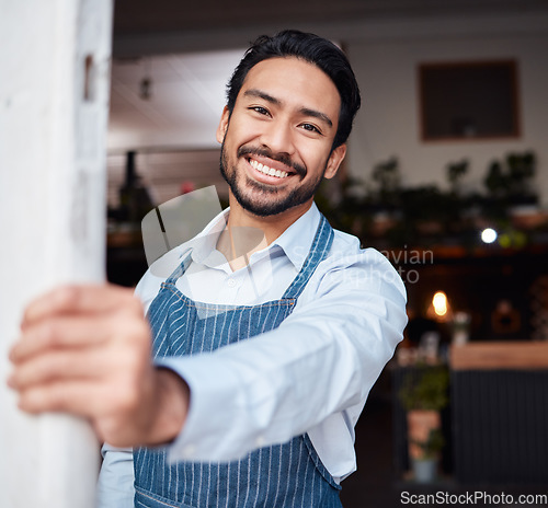 Image of Happy, portrait and male entrepreneur of a cafe standing by the door to welcome customers. Confident, proud and face of a young man small business owner with success at his modern startup coffee shop