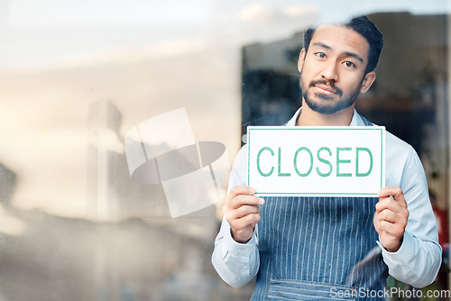 Image of Asian man, small business and closed sign for out of service in coffee shop or restaurant closing. Portrait of male entrepreneur, manager or waiter holding billboard or poster sorry for close in cafe