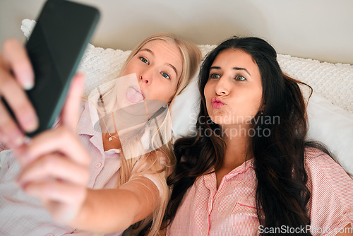 Image of Top view, selfie and women in bed, funny and happiness on break, silly and goofy. Females, friends and young people with social media, home and waking up on weekend, profile picture and bedroom