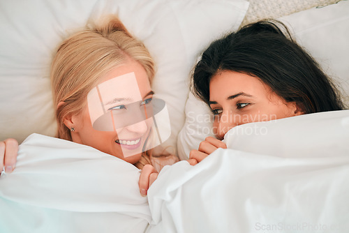 Image of Love, above and lesbian couple in bed, waking up and bonding in their home together. Lgbt, gay and happy women sharing romance, relationship and sweet moment in a bedroom, in love and content