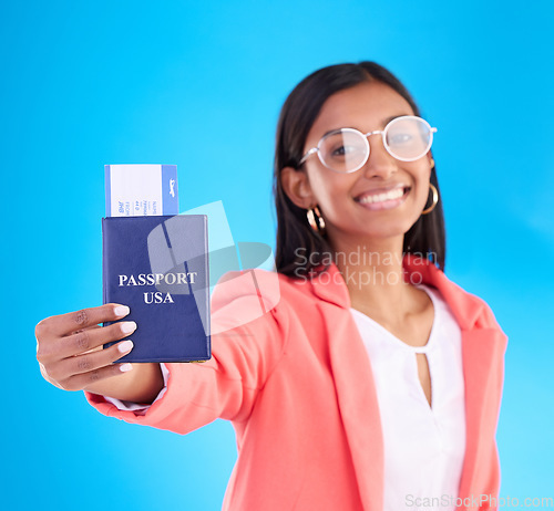 Image of Passport, ticket and portrait of woman in travel, flight or USA documents against a blue studio background. Happy female business traveler smile holding international boarding pass or booking trip