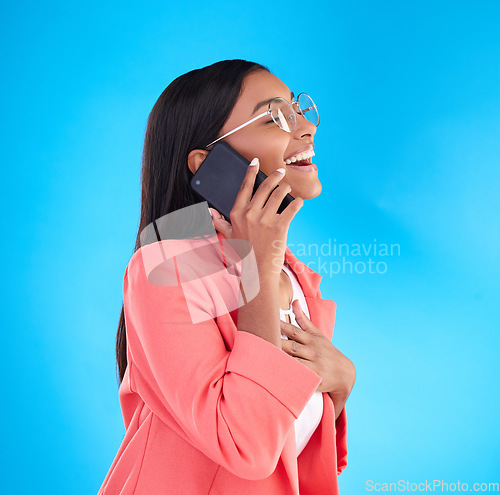 Image of Happy business woman, phone call and laughing for funny joke, meme or conversation against a blue studio background. Female employee laugh, humor and talking on mobile smartphone in fun discussion