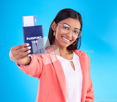 Image of Happy woman, passport or ticket for travel, flight or USA documents against a blue studio background. Portrait of female business traveler smile holding international boarding pass or booking trip