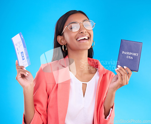 Image of Happy woman, passport and ticket for travel, flight or USA documents against a blue studio background. Portrait of female business traveler smile holding international boarding pass or ID for trip