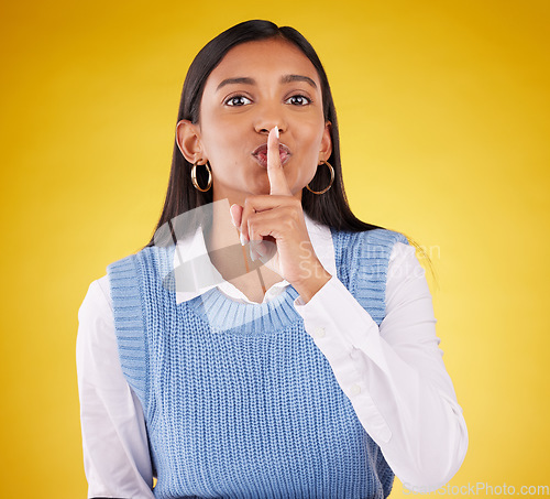 Image of Portrait, secret and woman with finger on lips, private and whisper on a studio background. Face, female person or girl with gesture for quiet, silence and secrecy with privacy sign, gossip and emoji