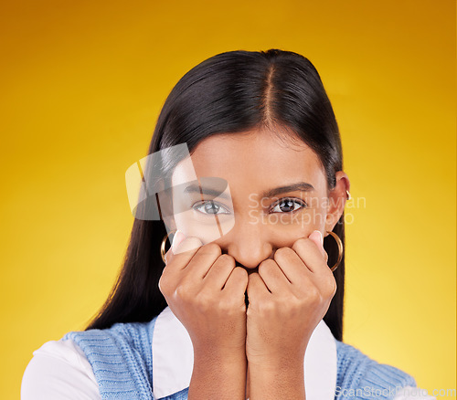 Image of Portrait, wow and excited with a woman on a yellow background in studio looking shocked or in awe. Face, surprise and omg with an attractive young female standing hands over mouth in amazement