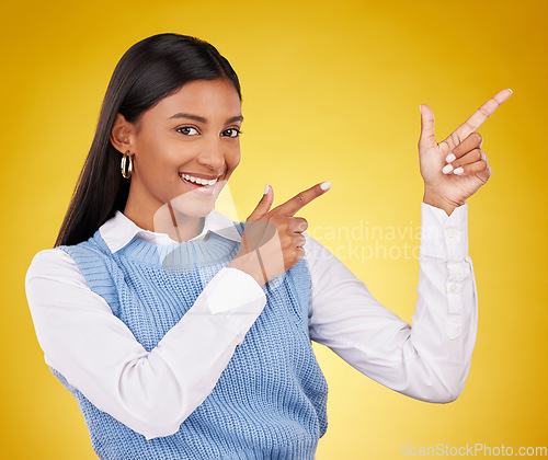 Image of Woman, portrait and gun fingers in a studio pointing with emoji hand gesture with a smile. Happiness, business female and happy youth with proud and cool hands sign in isolated yellow background