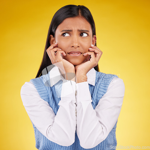 Image of Thinking, confused and woman in doubt with anxiety, stress and ideas isolated on yellow background. Fear, concentration on face and difficult choice or thought for gen z model in studio mockup space.