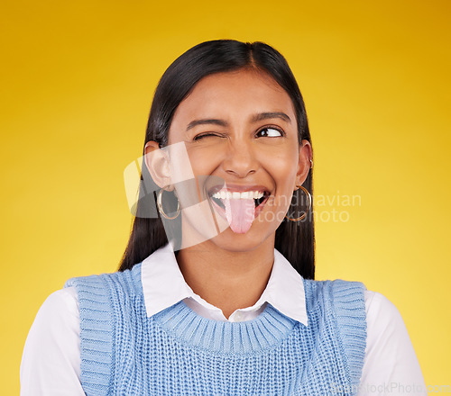 Image of Funny, emoji and woman with tongue out, happy and cheerful against a studio background. Female, stress relief and girl with facial expression, humor and goofy action for joy, crazy and happiness