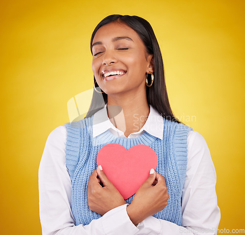 Image of Satisfaction, paper and heart with woman in studio for love, support and romance. Valentines day, kindness and date with female and symbol mockup on yellow background for health, happiness and hope