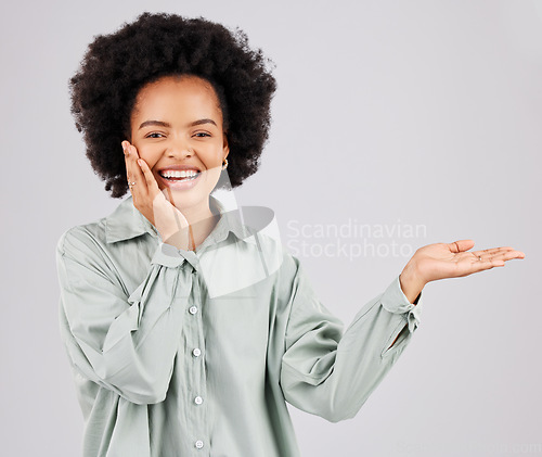 Image of Portrait, product placement and black woman smile in studio isolated on a white background. Hand, space and happiness of person with advertising, marketing or branding, mockup or commercial promotion