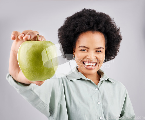 Image of Portrait, apple and black woman smile in studio isolated on a white background. Food, fruit and happiness of person with vitamin c, nutrition or healthy diet, wellness or nutritionist, vegan or detox