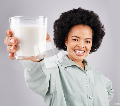 Image of Portrait, happy woman and glass of milk in studio, white background and backdrop for healthy diet. Female model, food and calcium of smoothie, vanilla milkshake and nutrition of weight loss drink