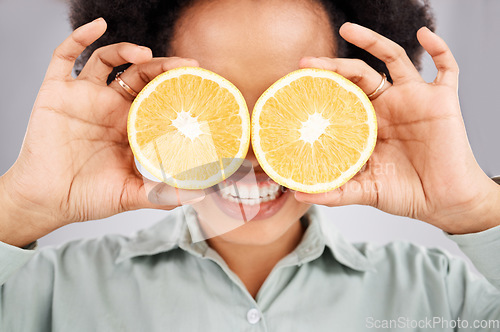 Image of Lemon eyes, health and face of black woman in studio for nutrition, wellness and healthy snack. Food, diet and girl smile with organic fruit for detox, vitamins and weight loss on white background