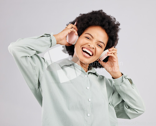 Image of Portrait, music headphones and black woman singing in studio isolated on white background. Singer, radio and happiness of person listening, streaming and enjoying audio track, sound album or podcast.