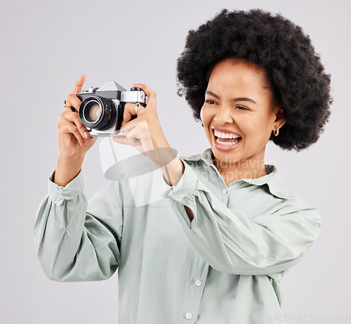 Image of Laughing, camera photographer and black woman in studio isolated on a white background. Photography, professional and funny person or female ready to start filming, photoshoot or taking picture.