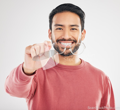 Image of Glasses, happy man and portrait in a studio with a smile from vision showing eye care product. Isolated, white background and happiness of a Asian male model with lens prescription and frame check