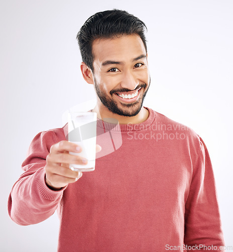 Image of Milk, man and portrait with happiness in a studio with calcium, healthy and nutrition drink. Isolated, white background and male model with a smile feeling happy from weight loss and detox smoothie