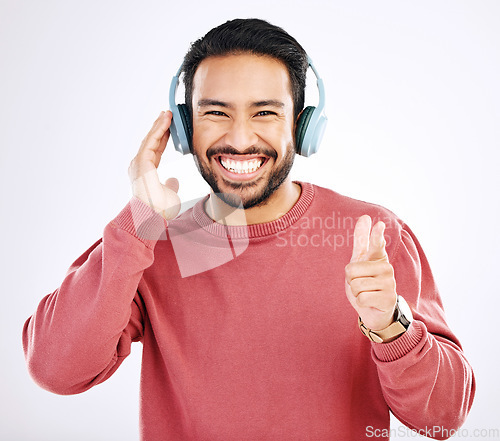 Image of Headphones, smile and music, excited man in studio isolated on white background streaming radio and happiness. Podcast subscription, technology and song, Indian guy listening to audio online to relax