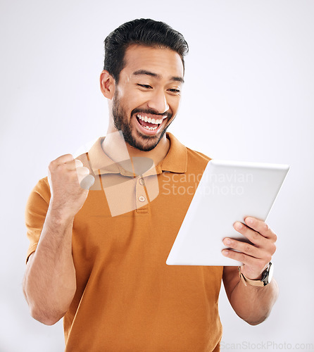 Image of Tablet winner news, reading and happy man celebrate achievement, success goals or winning. Excited, studio and male celebration fist pump, victory announcement or notification on white background