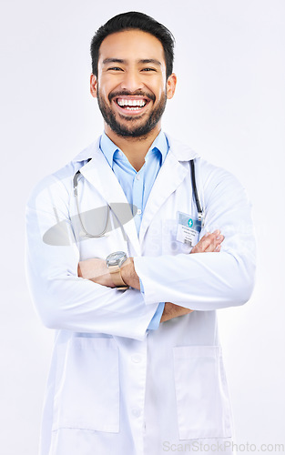 Image of Portrait, doctor and Asian man with arms crossed, smile and confident guy isolated on white studio background. Face, male employee and medical professional with leadership, experience and healthcare