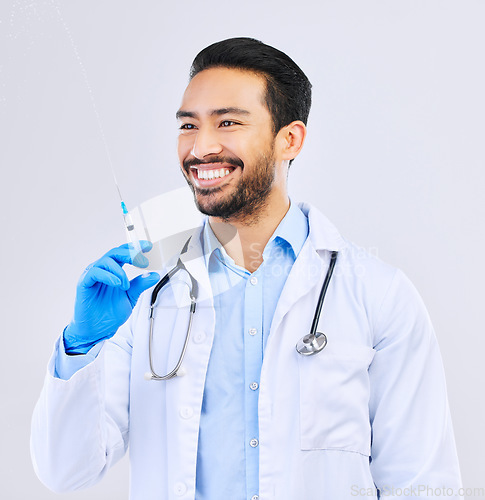 Image of Doctor with smile, syringe and vaccine in studio for healthcare, medicine and medical innovation. Vaccination, booster shot and happy Asian man with needle for virus protection on white background.