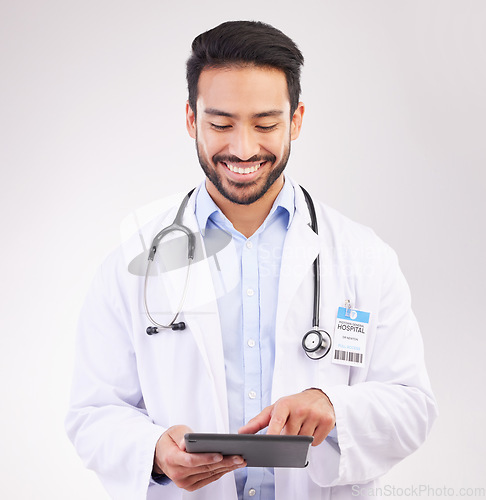 Image of Happy asian man, doctor and tablet in healthcare research, Telehealth or communication against a white studio background. Male medical professional smiling on touchscreen for good health results