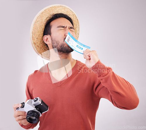 Image of Excited man, ticket and visa with camera, travel and paperwork for holiday adventure and on white background. Smile, travel and happy person kissing boarding pass for vacation, journey and happiness.