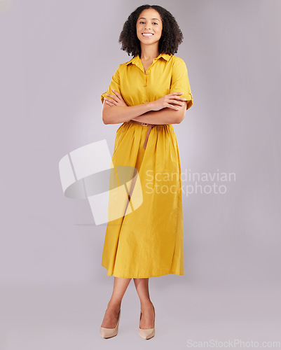 Image of Business woman, confident and portrait smile standing with arms crossed against a gray studio background. Isolated and stylish African American female model with afro smiling in confidence on mockup