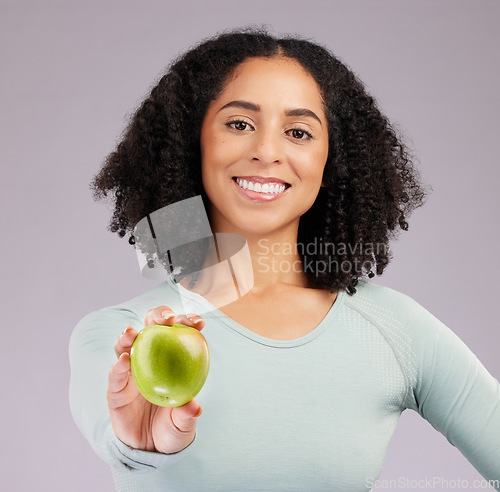 Image of Happy woman, portrait and smile with apple for diet, natural nutrition or vitamins against white studio background. Female model smiling and holding organic fruit in healthy dieting, food or wellness