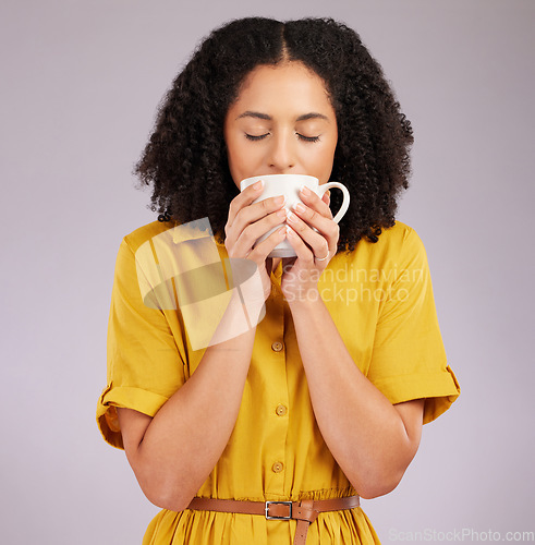 Image of Woman, coffee and drinking mug in studio, backdrop and background for warm beverage, latte and smell of espresso. Female model enjoying cup of tea, cappuccino and good mood for break, calm and peace