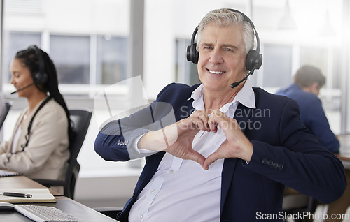 Image of Portrait, heart hands or mature happy man in call center with smile excited about customer care services in office. Sales, communication or friendly senior consultant with love sign at crm business
