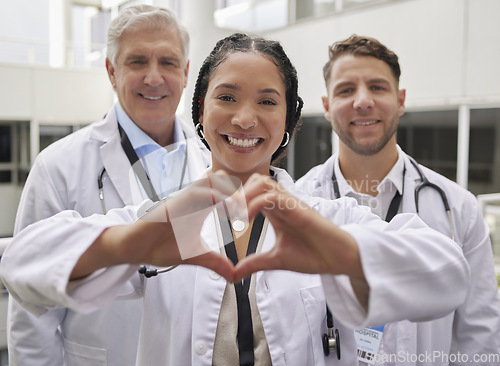 Image of Heart hand, woman doctor and portrait with a healthcare and wellness team in a hospital. Happiness, love and emoji hands gesture with doctors in a medical clinic showing solidarity and community care