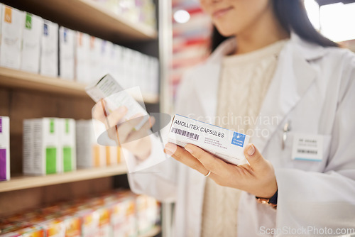 Image of Pharmacist, hands and medicine box, pills or medication for healthcare or wellness. Medical professional, product and woman with antibiotics, pharmaceutical supplements and reading label in pharmacy.
