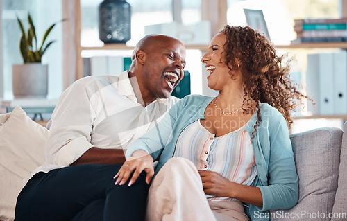 Image of Love, happy and couple laugh on sofa for bonding, quality time and relaxing together at home. Marriage, interracial relationship and man and woman on couch embrace, hugging and laughing at funny joke