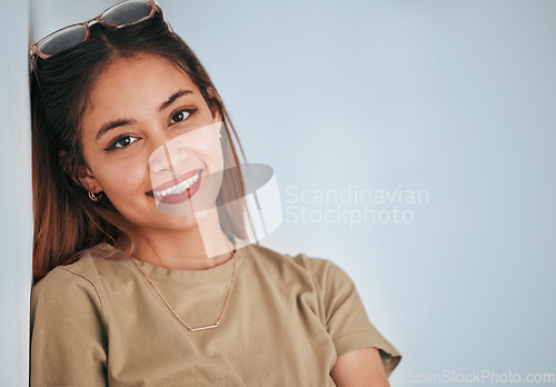 Image of Happy, smile and portrait of a woman in a studio with a casual, fashion and trendy outfit. Happiness, excited and face of a female model from Puerto Rico with a positive mindset by a gray background.