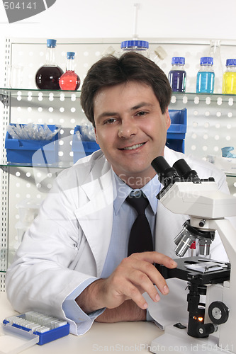Image of Researcher scientist  sitting at laboratory desk