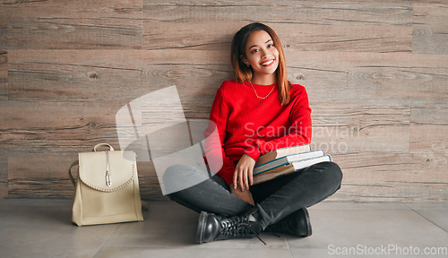 Image of University, portrait of woman with books and smile on floor, education at college on wall background mockup. Information, knowledge and space, student with backpack and happiness with book to study.