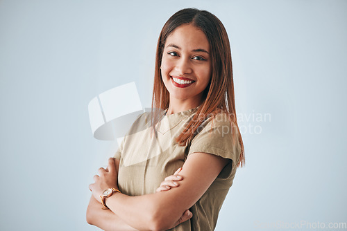 Image of Woman, proud portrait and happiness with arms crossed of a gen z female in a studio with gray background. Isolated, happy and smile from a person feeling motivation, youth and confidence with pride