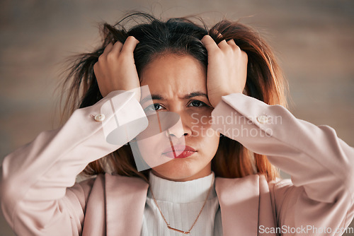 Image of Portrait, stress and woman in office with anxiety, problem or mental health issue on wall background. Frustrated, lady and face of corporate employee suffering burnout, angry or headache from vertigo