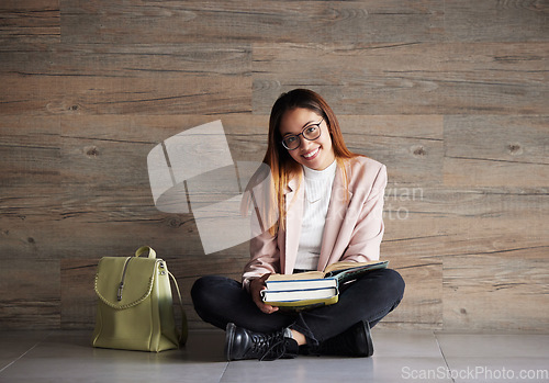 Image of University, portrait of happy woman on floor with books on mockup space and education at college. Information, knowledge and backpack, student sitting on wall background with smile and book to study.