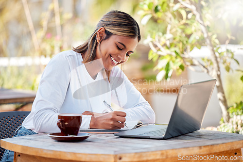 Image of Woman with smile, writing notes and student, education with study and online course, elearning and university. Female at outdoor cafe, distance or remote learning with research for school project