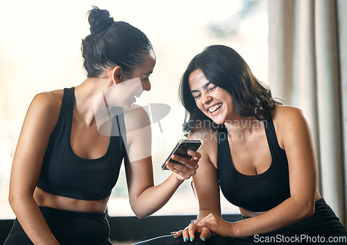Image of Fitness, funny and women with smartphone, exercise and fun after workout, training and friends. Female athletes, girls and partners with cellphone, meme or social media with smile, practice and break