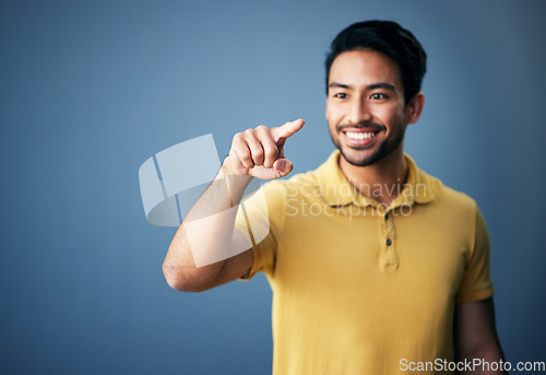 Image of Happy, finger and man in studio with hand for mockup space or ai on a blue background. Smile of an asian male model person pointing for product placement and creative brand isolated for gradient logo