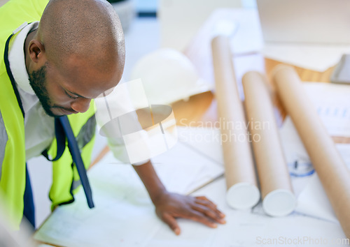 Image of Blueprint, architect and black man in office with paper, design and creative, building and planning. Construction, engineer and male project manager with plan for property, model or renovation