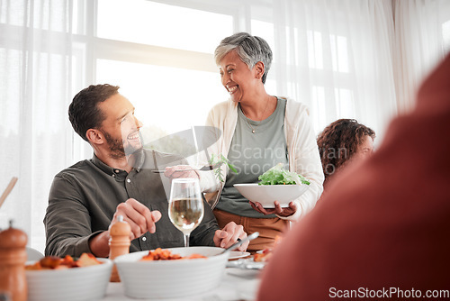 Image of Family, dinner and party with happiness while eating together, love and food with celebration and holiday. Man with senior woman, relationship and hungry people with meal, happy and carefree